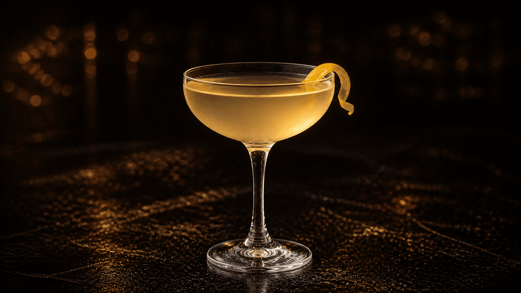 Bee's Knees i coupeglas med klar ljusgul cocktail och liten citronzest.